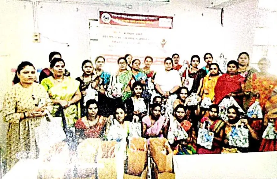 Workshop participants holding finished fabric and paper bags